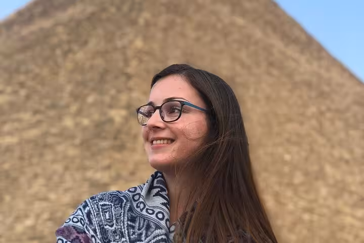 Smiling visitor at the Giza Pyramids viewpoint during a private Cairo tour with Sphinx and ATV quad bike