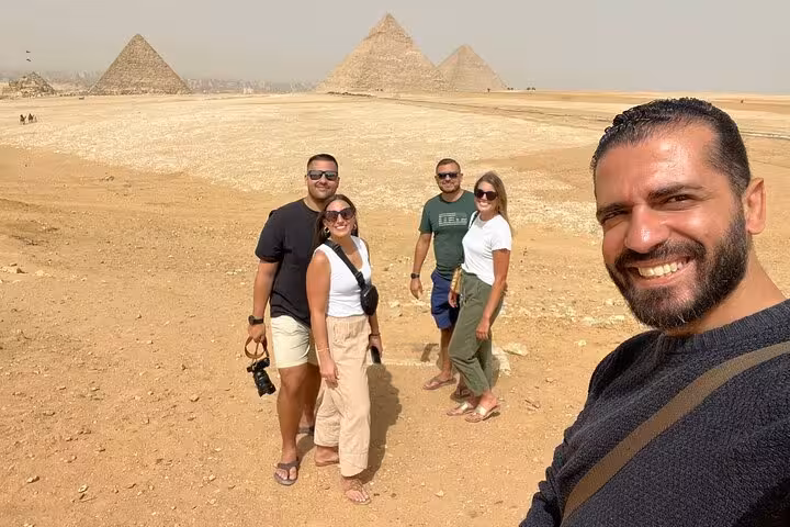 Small group with local guide at Giza Pyramids on private Cairo tour including Sphinx visit, lunch and camel ride