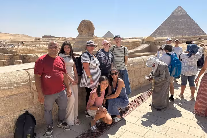 Group photo at the Great Sphinx and Giza Pyramids, Cairo day tour featuring camel rides, desert bikes and Nile felucca