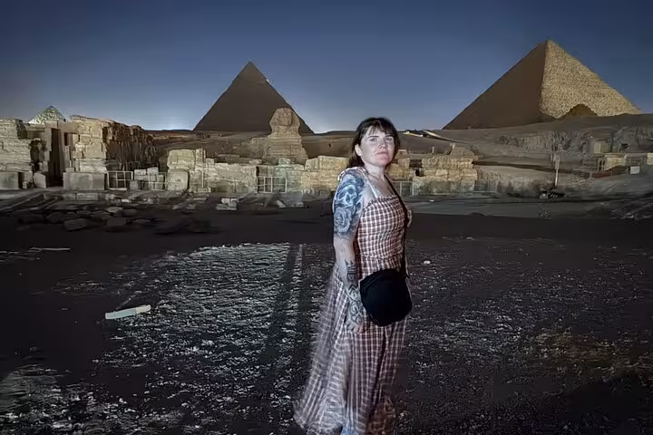 Traveler at Giza Pyramids and Sphinx at night, Cairo tour with camel rides, desert bikes and Nile felucca