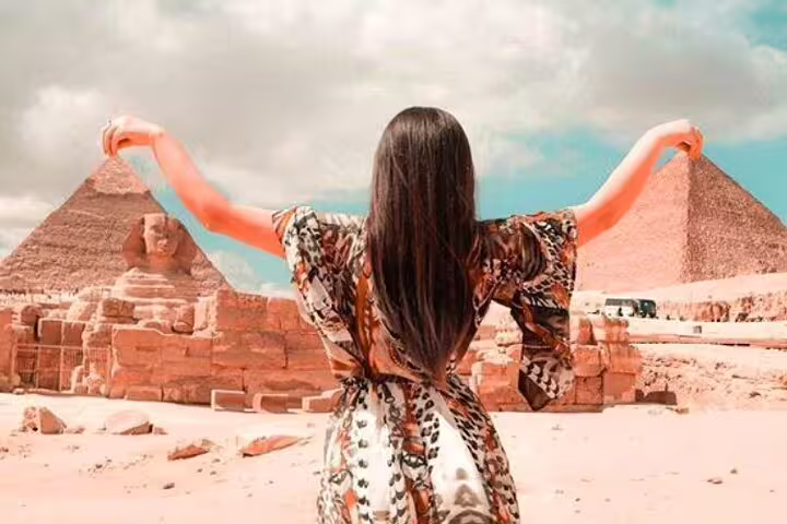 Traveler posing by the Sphinx and Giza Pyramids on a Port Said day trip tour with Nile River lunch