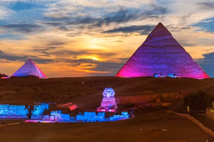 Sunset view of Giza Pyramids and Sphinx lit for Sound and Light Show, Cairo dinner experience with pyramid view