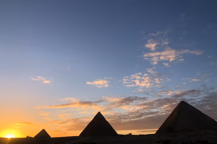 Sunset view of the Giza Pyramids skyline in Cairo, iconic highlight of a private full-day Egypt tour