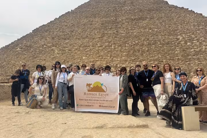 Tour group photo at the Great Pyramid of Giza during guided Giza Pyramids, Museum and Khan El Khalili tour