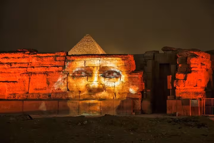 Giza Sound and Light Show projection on Sphinx temple wall with Great Pyramid backdrop, Cairo dinner tour