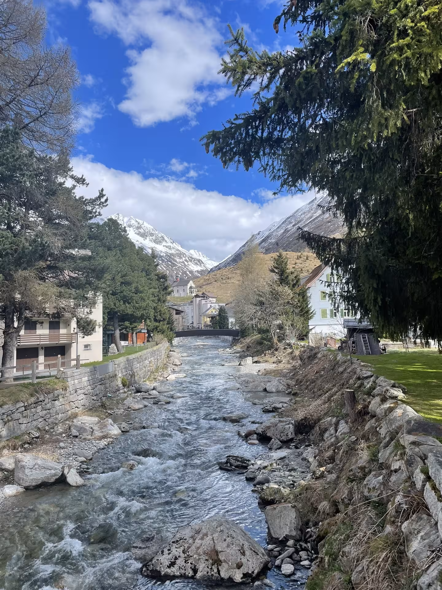 Alpine river in a Swiss mountain village on the Glacier Express route tour from Zurich, spring scenery