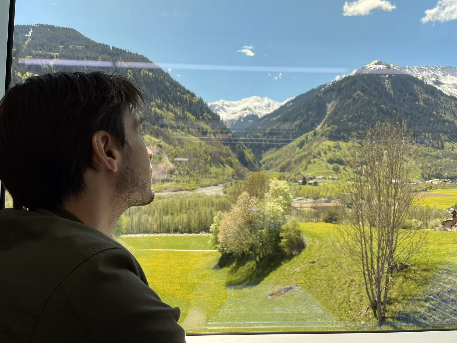 Passenger enjoying panoramic Swiss Alps and river views on Glacier Express route private tour from Zurich