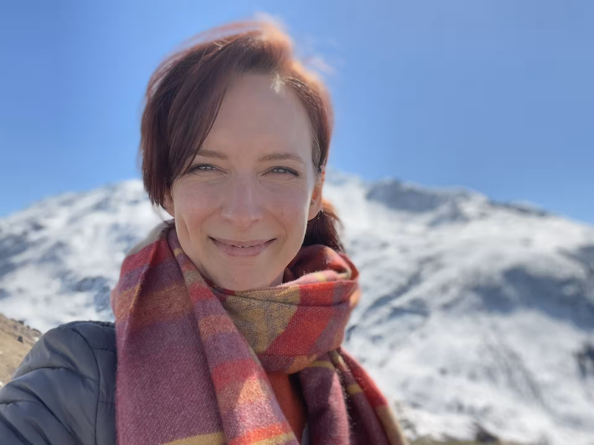 Traveler selfie with snowy Swiss Alps backdrop on premium Glacier Express route tour from Zurich