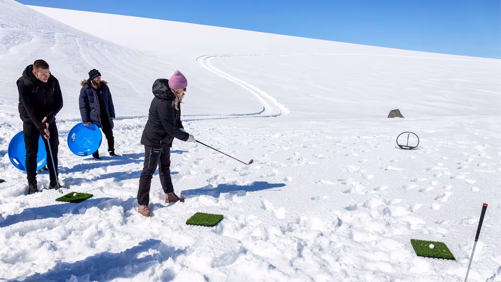 Guests play glacier golf on Langjökull during Red Glacier Monster Truck Tour from Gullfoss, Iceland