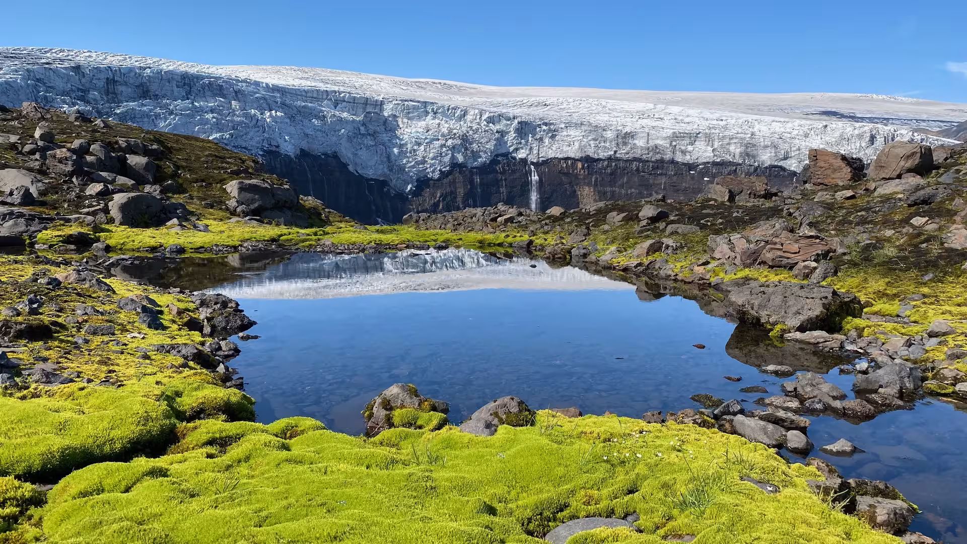 Glacier lagoon reflection and mossy lava rocks on Thakgil & hidden gems tour near Vík, Iceland