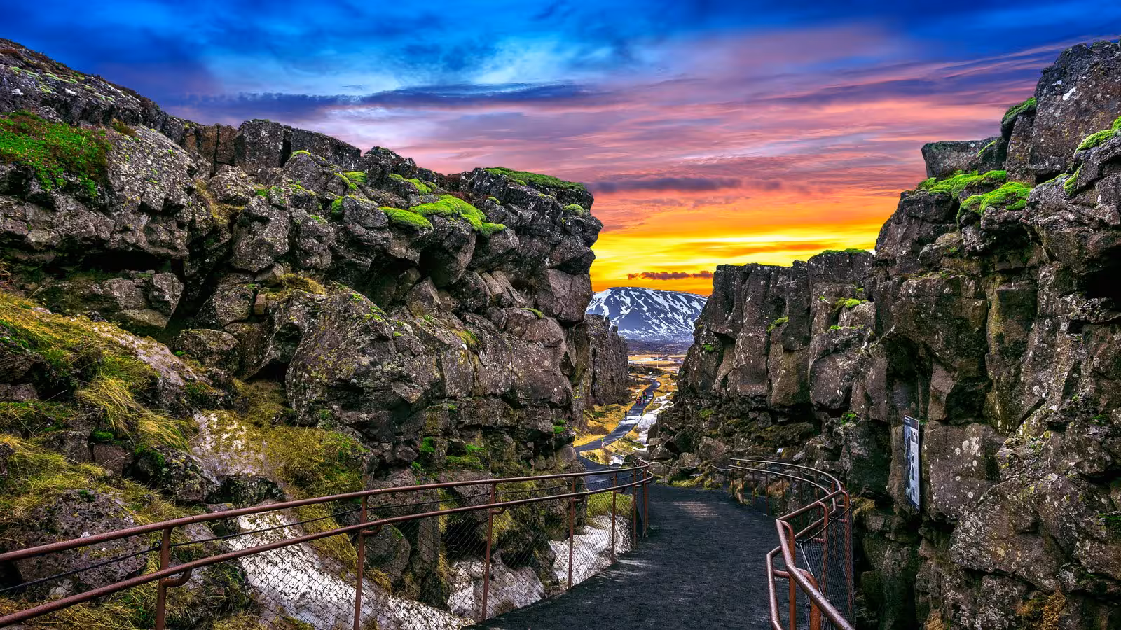 Spectacular sunset view over rocky cliffs and a winding path on the Glacier Lagoon Tour in Iceland.