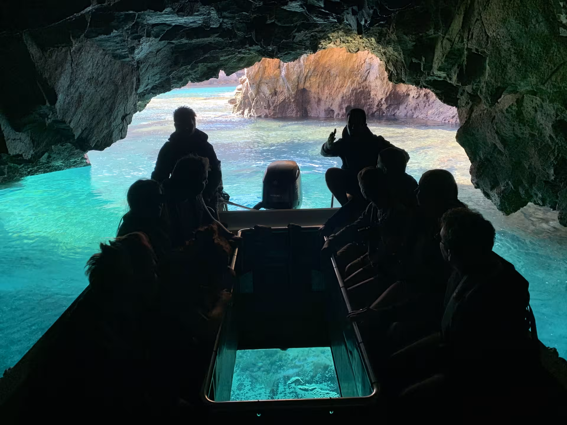 Glass-bottom boat cave tour in Berlengas, Portugal, with turquoise water and sea cliffs on Advanced Pack