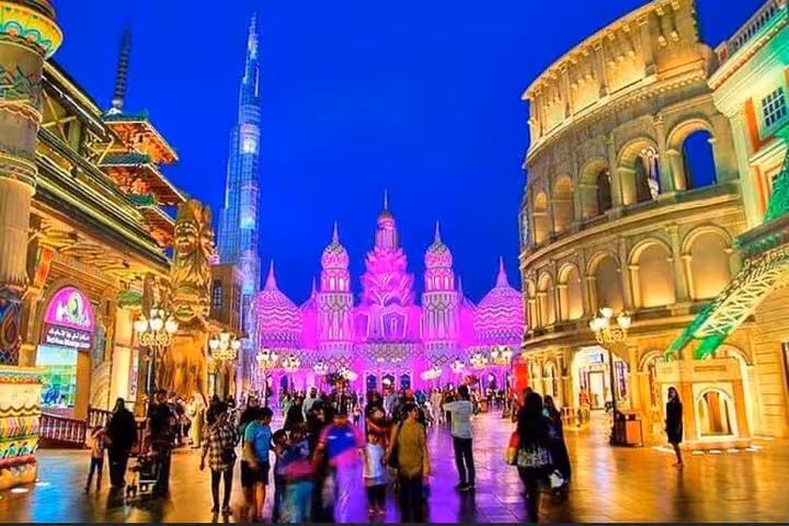 Global Village Dubai night street scene with Burj Khalifa view on private tour with pickup