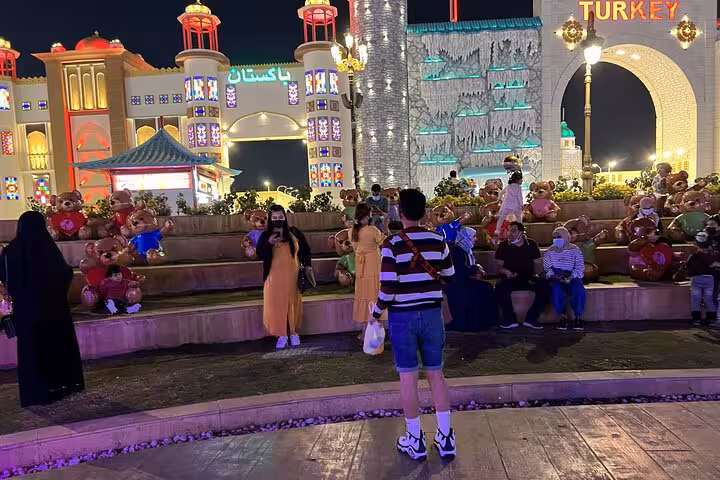 Night view of Global Village-style pavilions and crowds, included with Ras Al Khaimah adventure pass