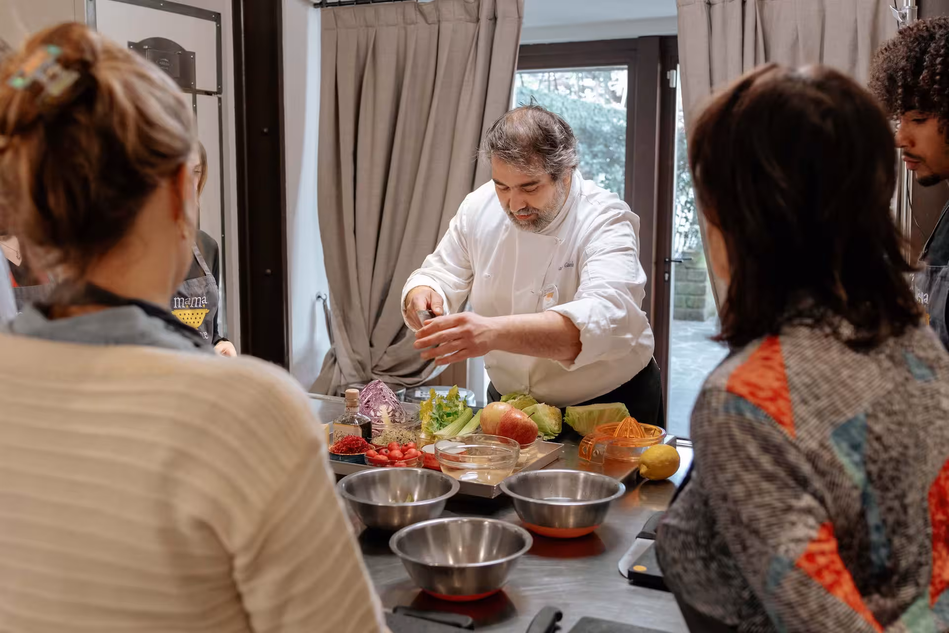 Chef demonstrating gluten-free culinary techniques to attentive participants in a hands-on cooking class.