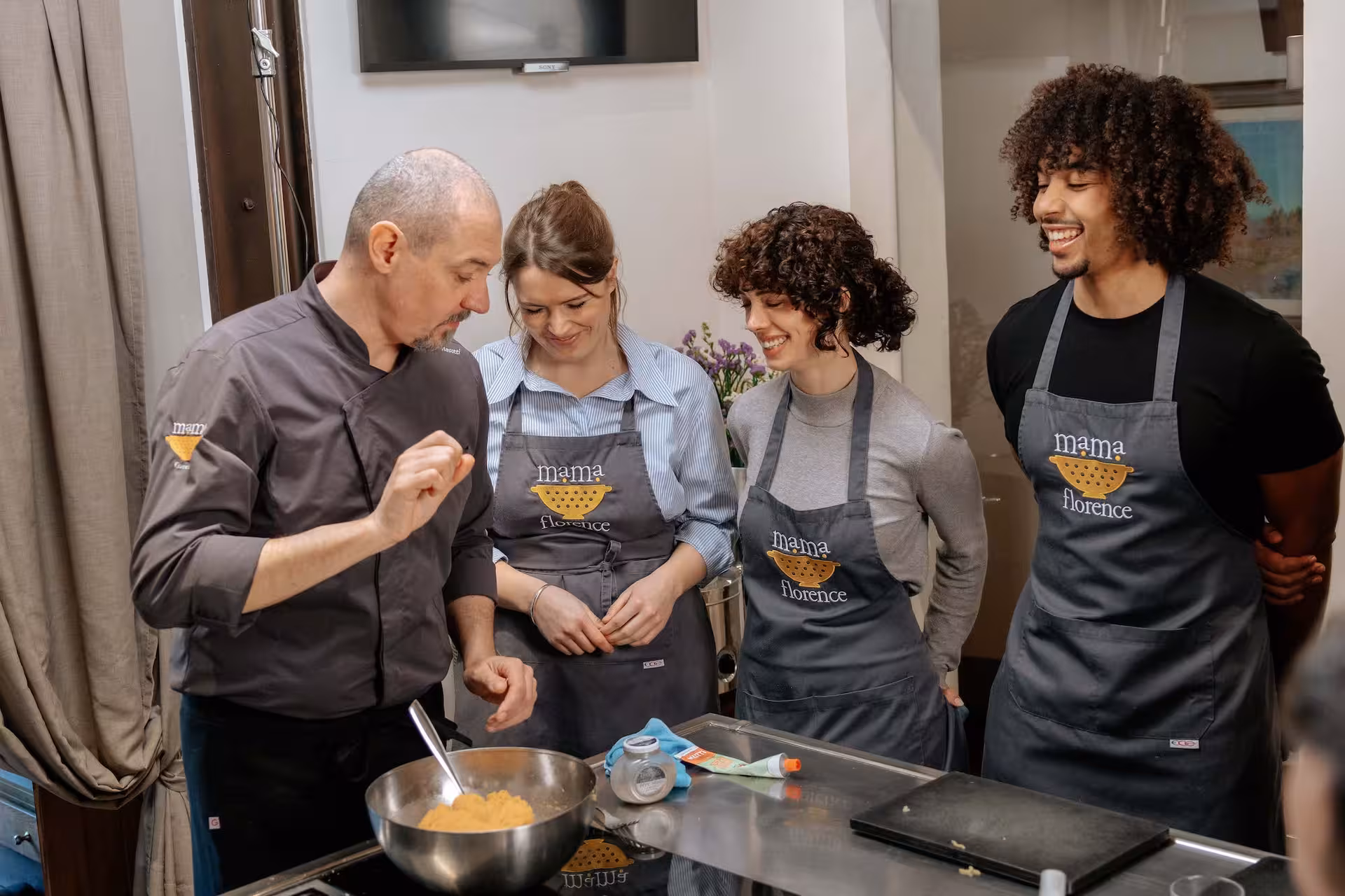 Enthusiastic group learning gluten-free recipes from an expert chef in an engaging cooking class session.