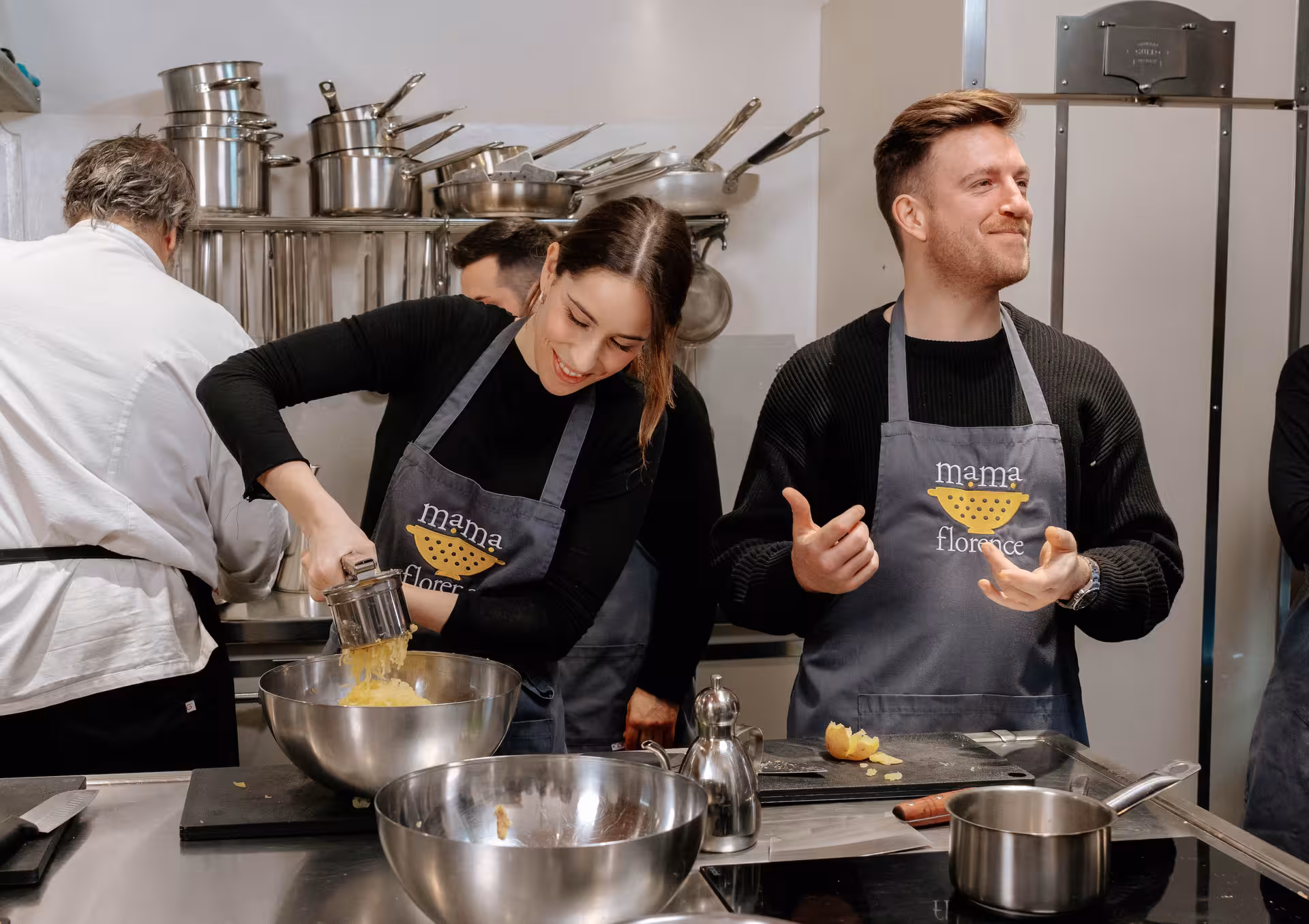 Participants in a gluten-free cooking class enjoy preparing dishes in a modern kitchen setting.