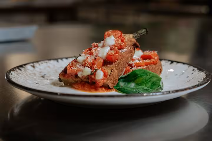 Delicious gluten-free Italian dish topped with tomatoes and cheese at MaMa Florence cooking class.