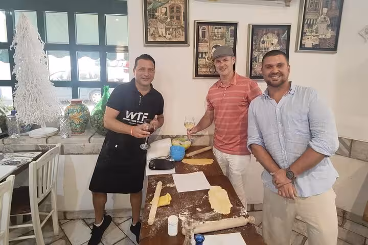 Three men enjoying a gluten-free pasta-making course in Rome, featuring hands-on preparation of three pasta types.