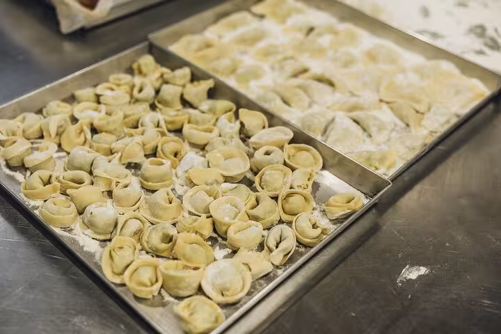 Freshly made gluten-free tortellini and ravioli on trays at MaMa Florence cooking class.