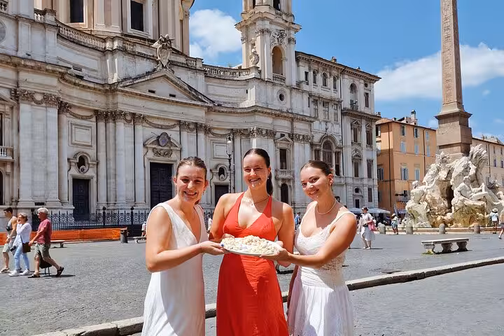 Participants enjoy hands-on learning at a gnocchi cooking class near Piazza Navona in Rome, guided by a professional chef.