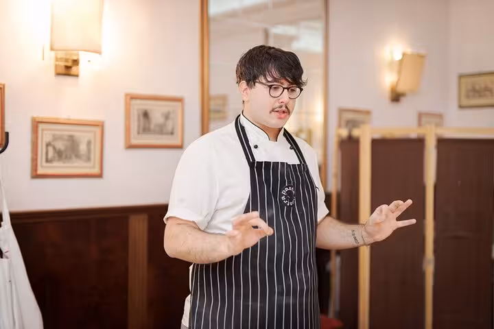 Chef instructing participants in a gnocchi cooking class at a cozy venue near Piazza Navona in Rome.