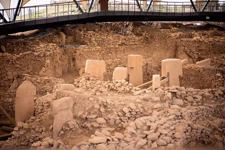Covered Göbeklitepe archaeological site with stone enclosures and pillars on an all-inclusive private Şanlıurfa tour