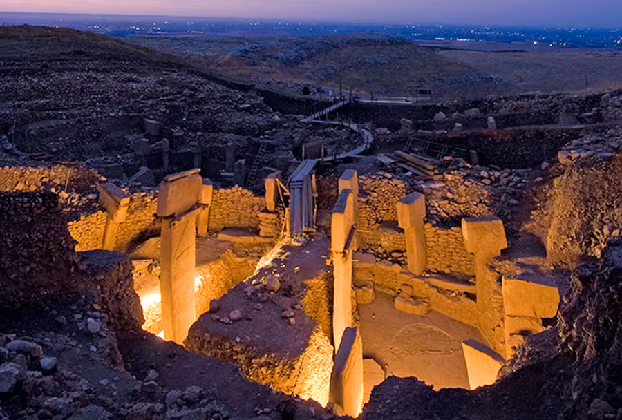 Twilight view of Göbeklitepe excavation with illuminated T-shaped pillars on Şanlıurfa tour in Turkey