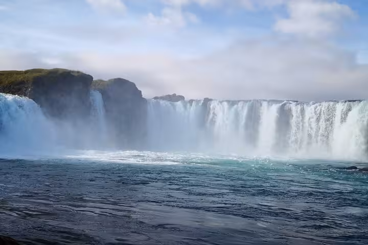Breathtaking view of Godafoss under a clear blue sky, highlighting the powerful waterfall, a must-see on Akureyri tours.