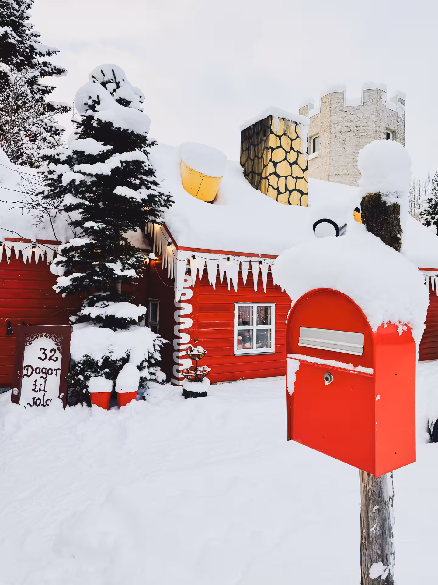 Snowy Akureyri Christmas House exterior with red mailbox, festive lights, on Goðafoss and Forest Lagoon tour