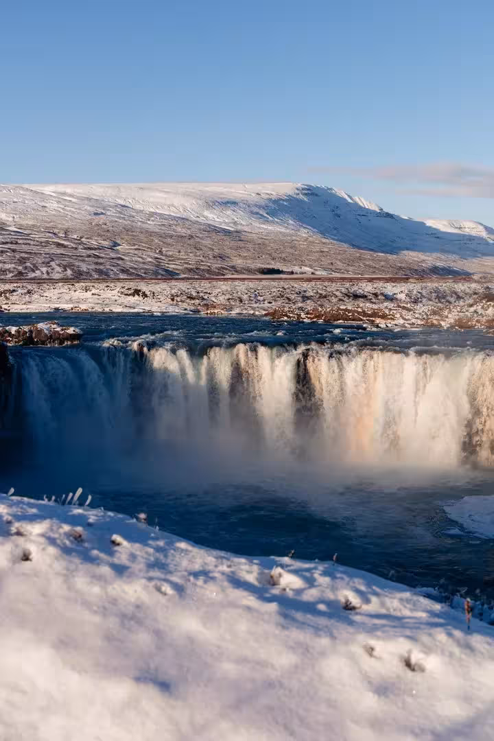 Goðafoss Waterfall in snowy winter landscape, North Iceland sacred adventure with Christmas dreams experience