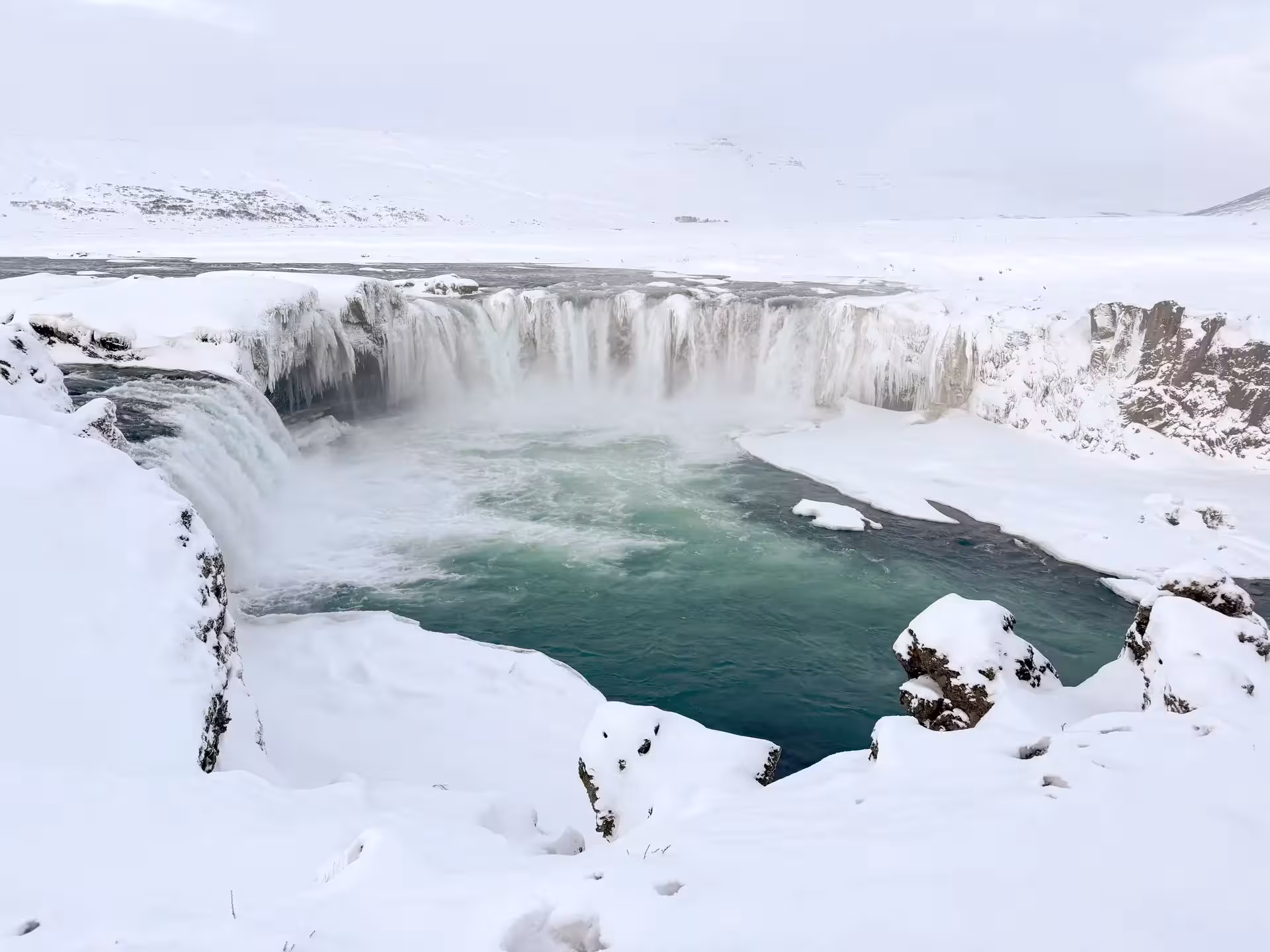 Snowy Goðafoss Waterfall viewpoint in North Iceland, winter private tour with Christmas dreams and cacao ceremony