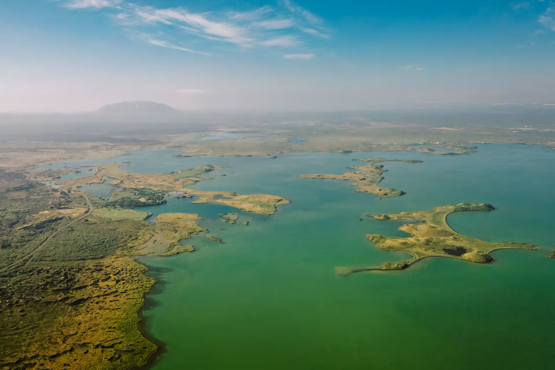 Aerial view of Lake Mývatn islands and turquoise water on Akureyri port tour to Goðafoss and baths