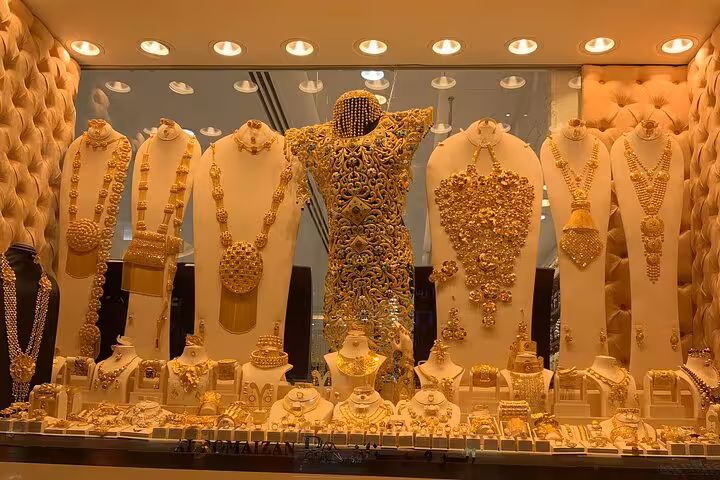 Gold Souk Dubai jewelry window display, luxury necklaces and ornaments on Dubai city tour from Ras Al Khaimah