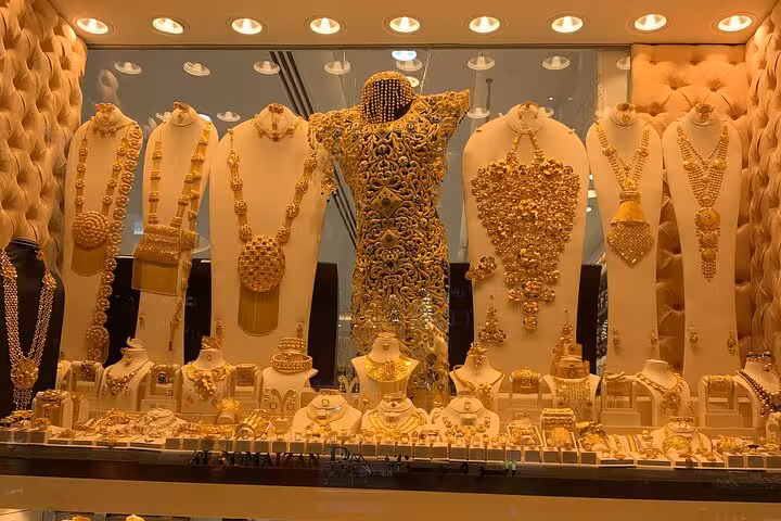 Gold Souk shop window with ornate 24k jewelry displays, featured on an Old Dubai cultural walking tour