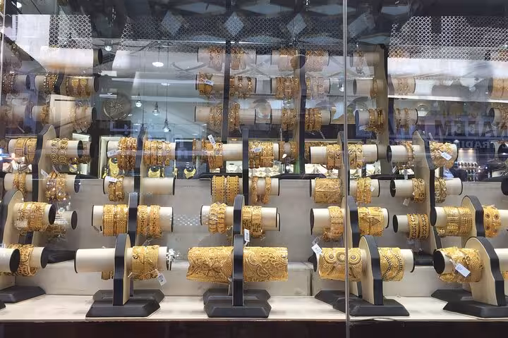 Gold Spice Souk AlSeef jewelry shop window with stacked bangles and cuffs on customizable Dubai mall tour