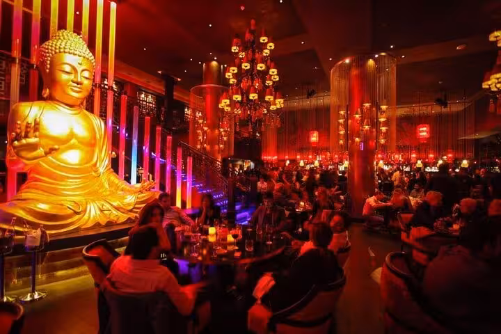 Golden Buddha statue inside Little Buddha Hurghada, lively lounge atmosphere on night out tour with transfer