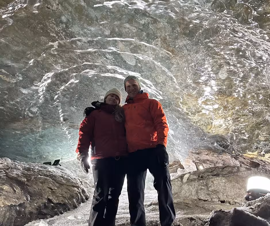 Couple of happy guests standing in the ice cave