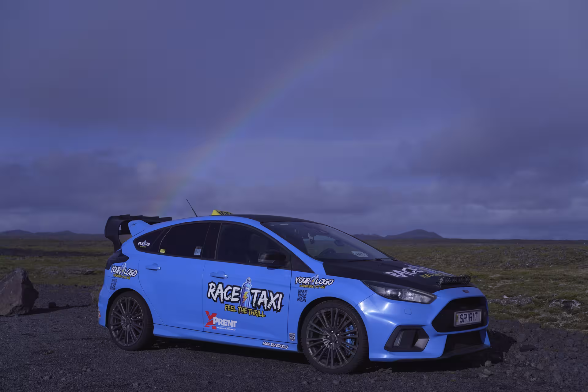 Race taxi rally car under a rainbow on Iceland gravel plains, Golden Circle Rally Car Experience tour