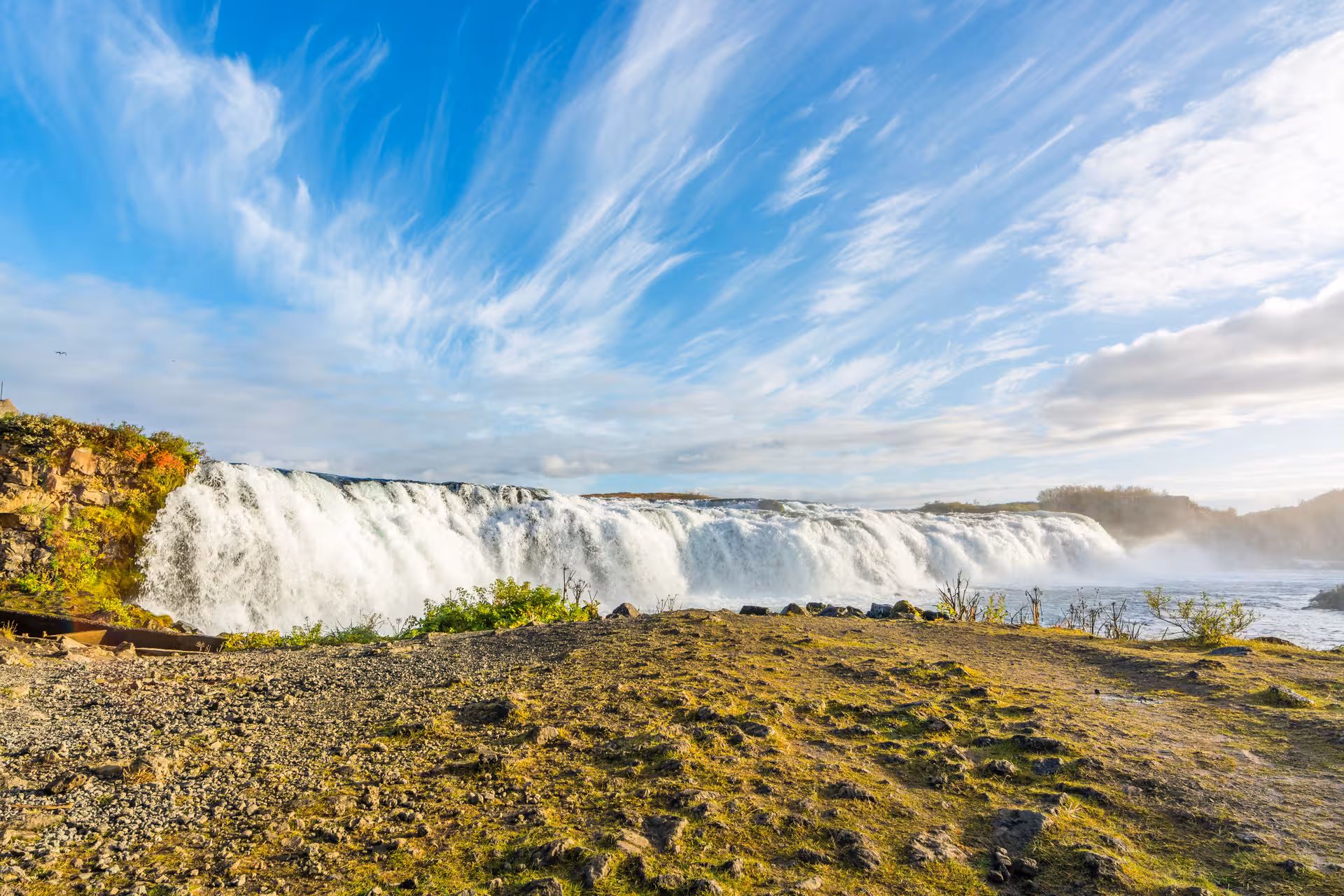 Stunning waterfall under a clear blue sky, a highlight of the Private Golden Circle with Geysers & Waterfalls tour.