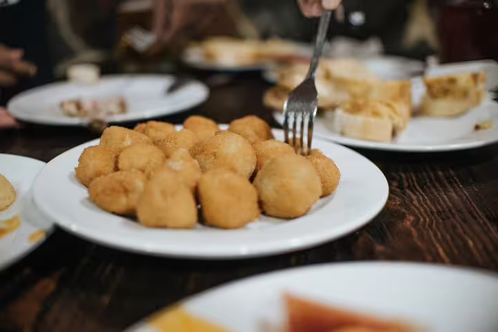 A plate of golden croquettes served during a Tapas Tour in Madrid, offering an authentic Spanish culinary experience.