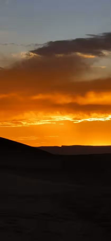 Golden sunset over Sahara sand dunes in Merzouga, Morocco, a highlight of Best of Morocco desert excursions