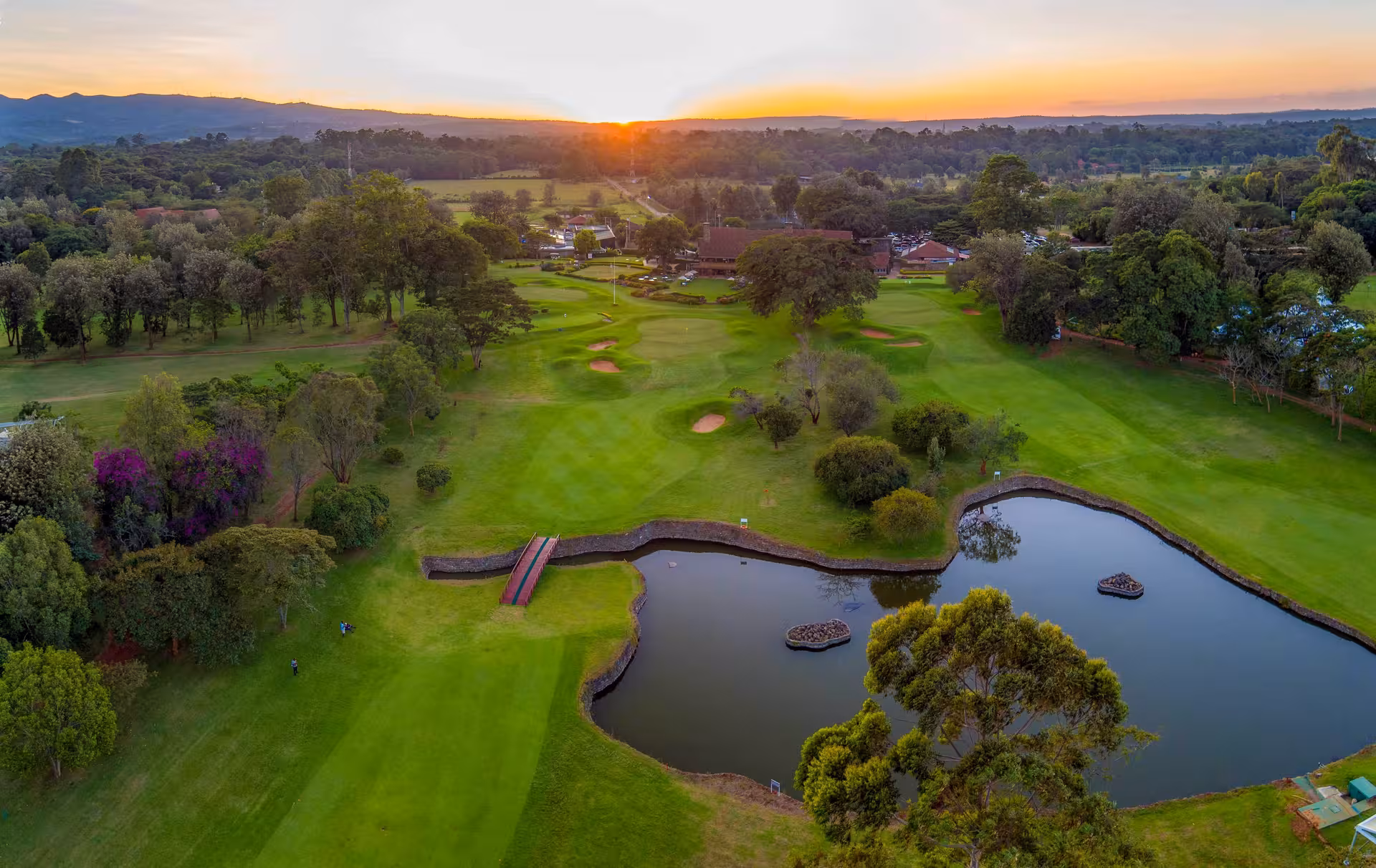 Aerial view of lush golf course at sunset in the Great Rift Valley, ideal for golf and safari adventures.