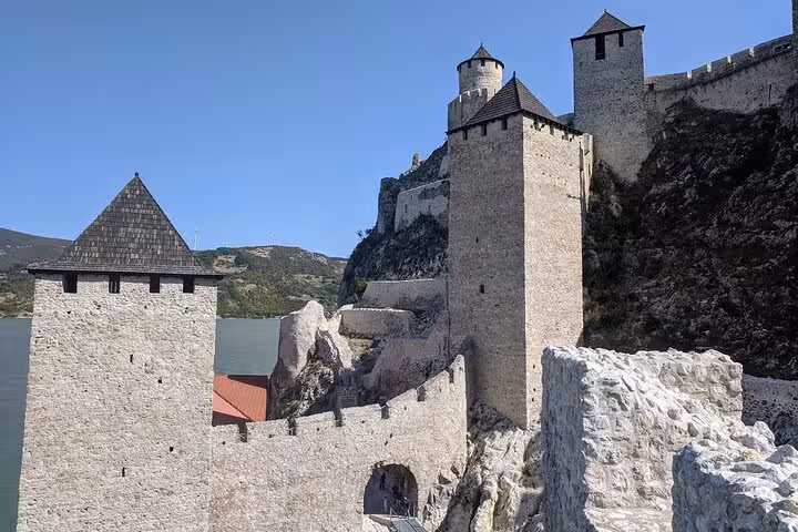 Majestic Golubac Fortress towers above the Danube River, showcasing medieval architecture and scenic views.