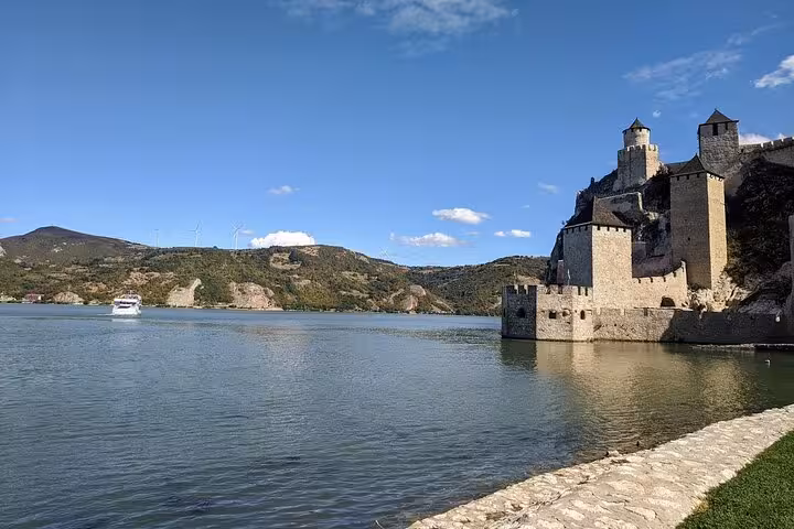 Scenic view of Golubac Fortress by the Danube River on a clear day during a private tour from Belgrade.