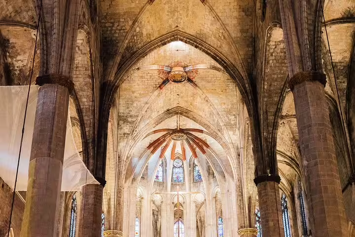 Gothic cathedral interior with stunning arches and stained glass, a highlight of the tapas and wine tour experience.