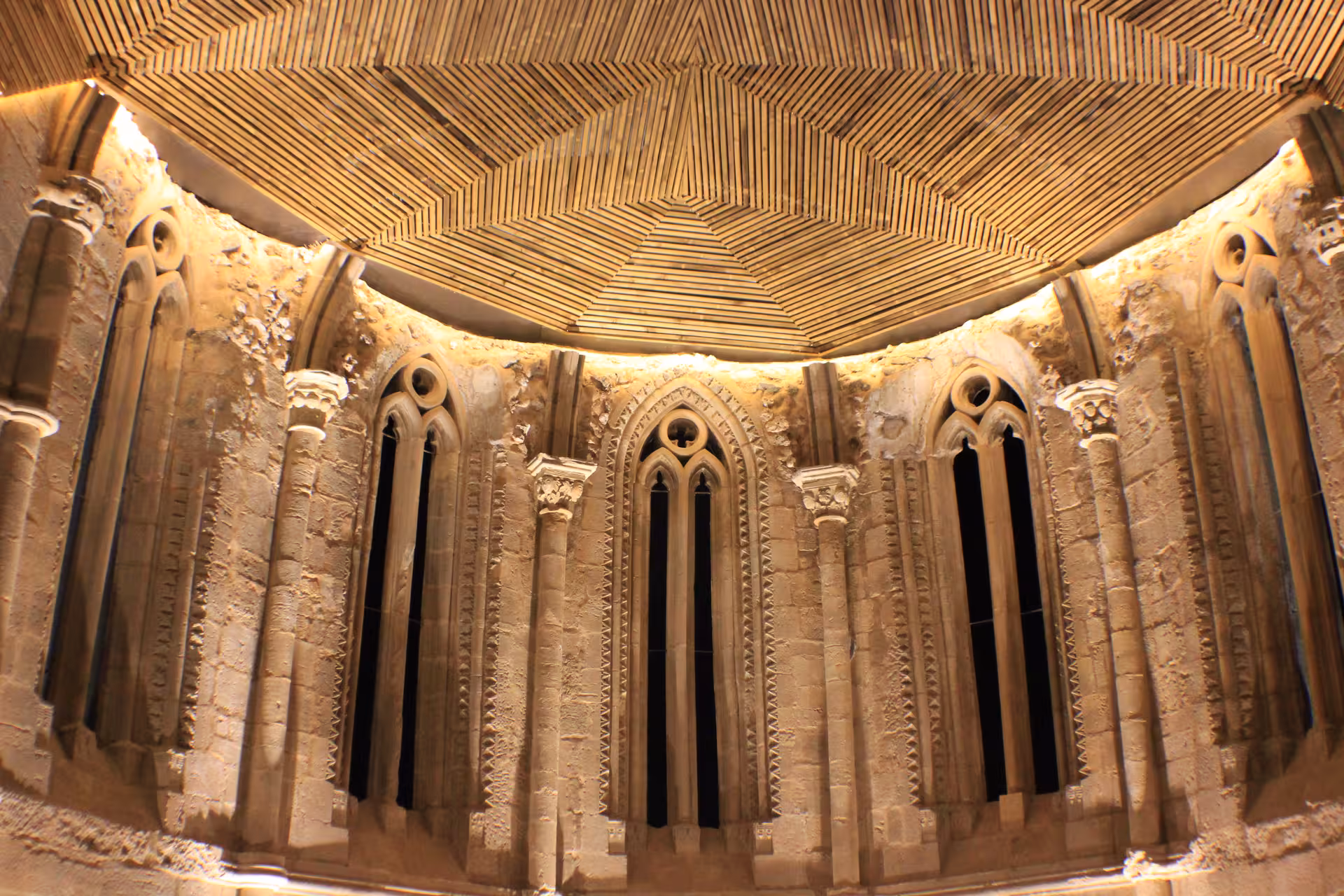Gothic chapel apse with pointed windows and carved stonework on the Guided tour of Huete Monumental