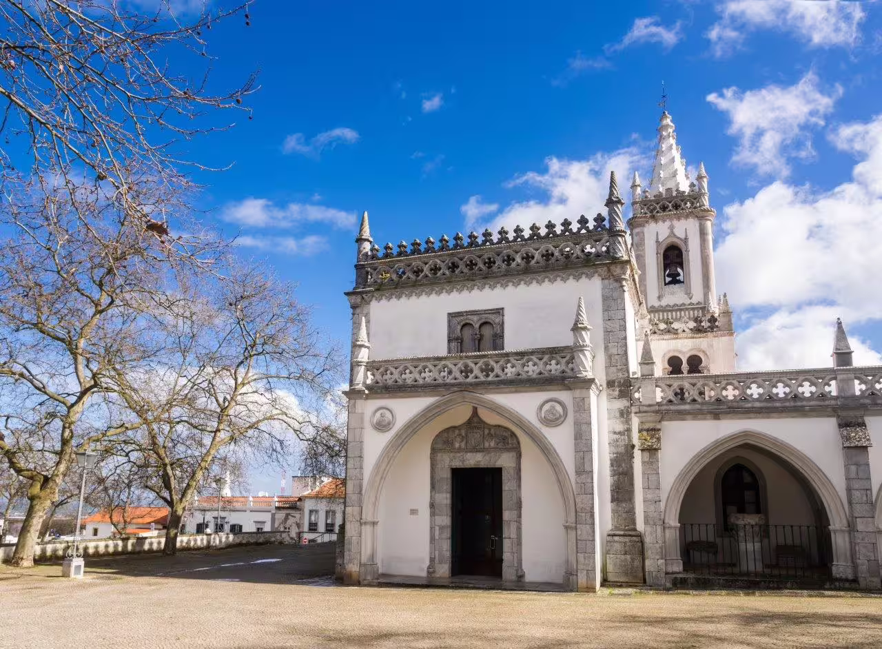 Gothic architecture of a historic church in Algarve under a bright blue sky, perfect for a self-drive tour exploration.
