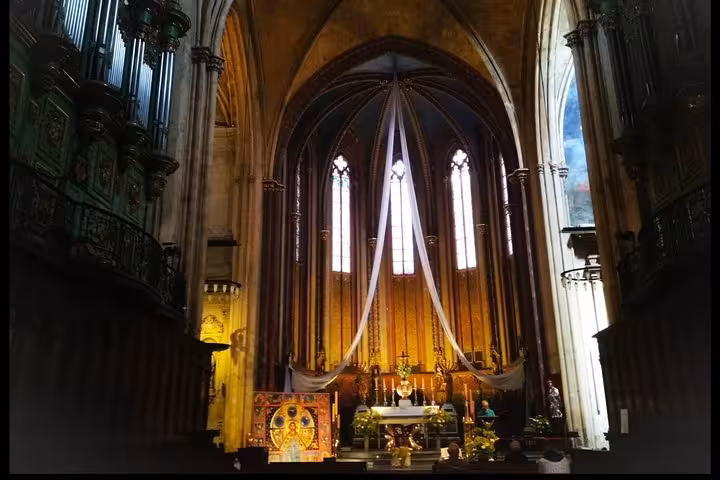 Gothic church interior in Provence with vaulted arches and altar, serene cultural stop on a self-paced tour