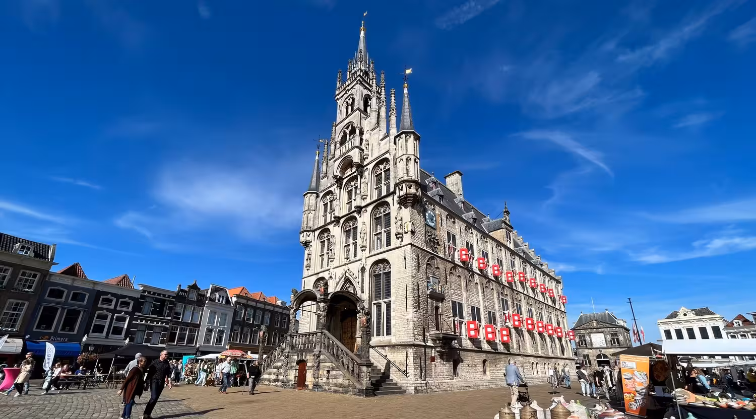 Gouda city hall on market square under blue sky, scenic stop on private tour from The Hague, Leiden or Noordwijk